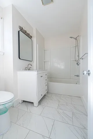 a bathroom with a sink a toilet and mirror