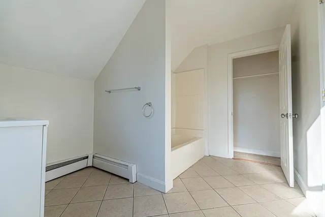 a view of an empty room and wooden floor