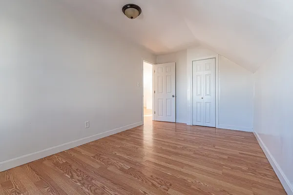 a view of an empty room and wooden floor