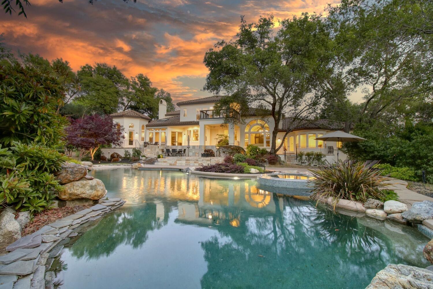 a view of swimming pool with outdoor seating and lake view