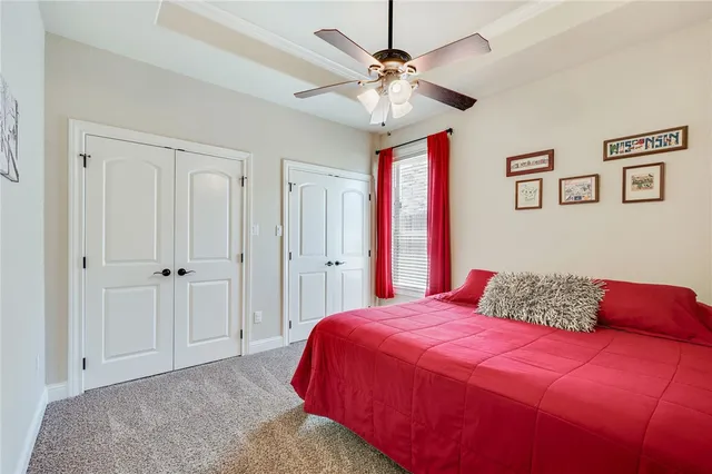 a bedroom with a large bed and a chandelier