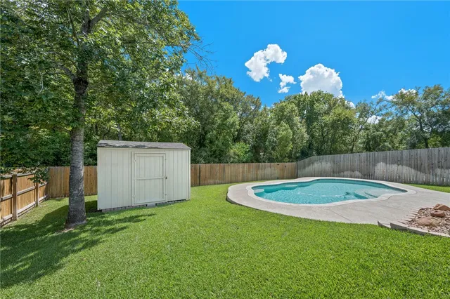 a view of a backyard with a trampoline