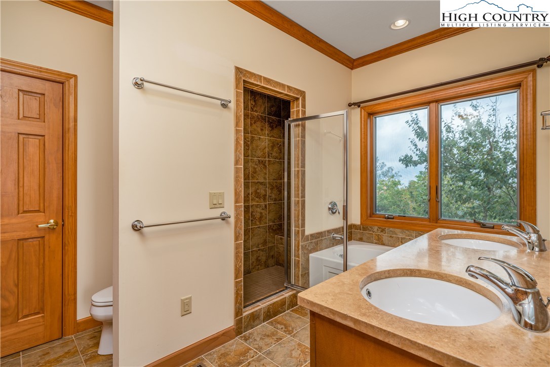 299 Trails End Extension, Unit 37C Sugar Mountain, NC 28604 - Photo 14 of 38 a bathroom with a sink a toilet and a shower