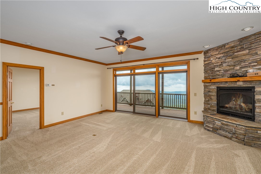 299 Trails End Extension, Unit 37C Sugar Mountain, NC 28604 - Photo 4 of 38 a view of an empty room with a fireplace and a window