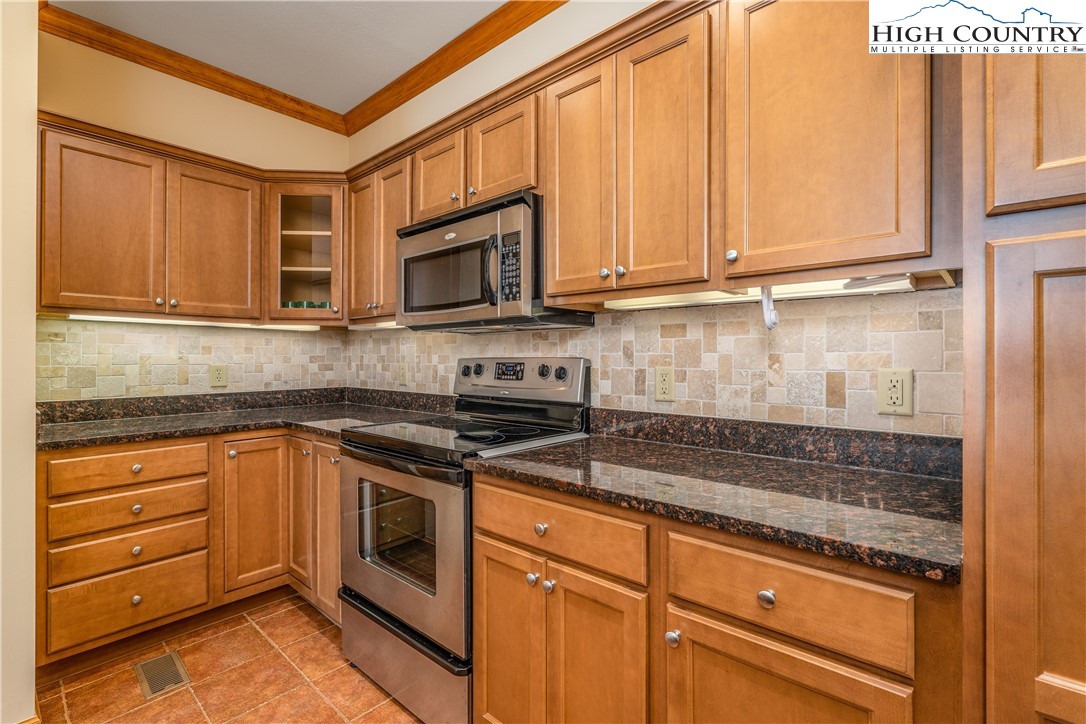 299 Trails End Extension, Unit 37C Sugar Mountain, NC 28604 - Photo 10 of 38 a kitchen with granite countertop cabinets stainless steel appliances and a sink