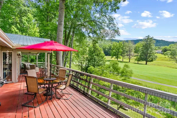 a view of balcony with furniture and umbrella