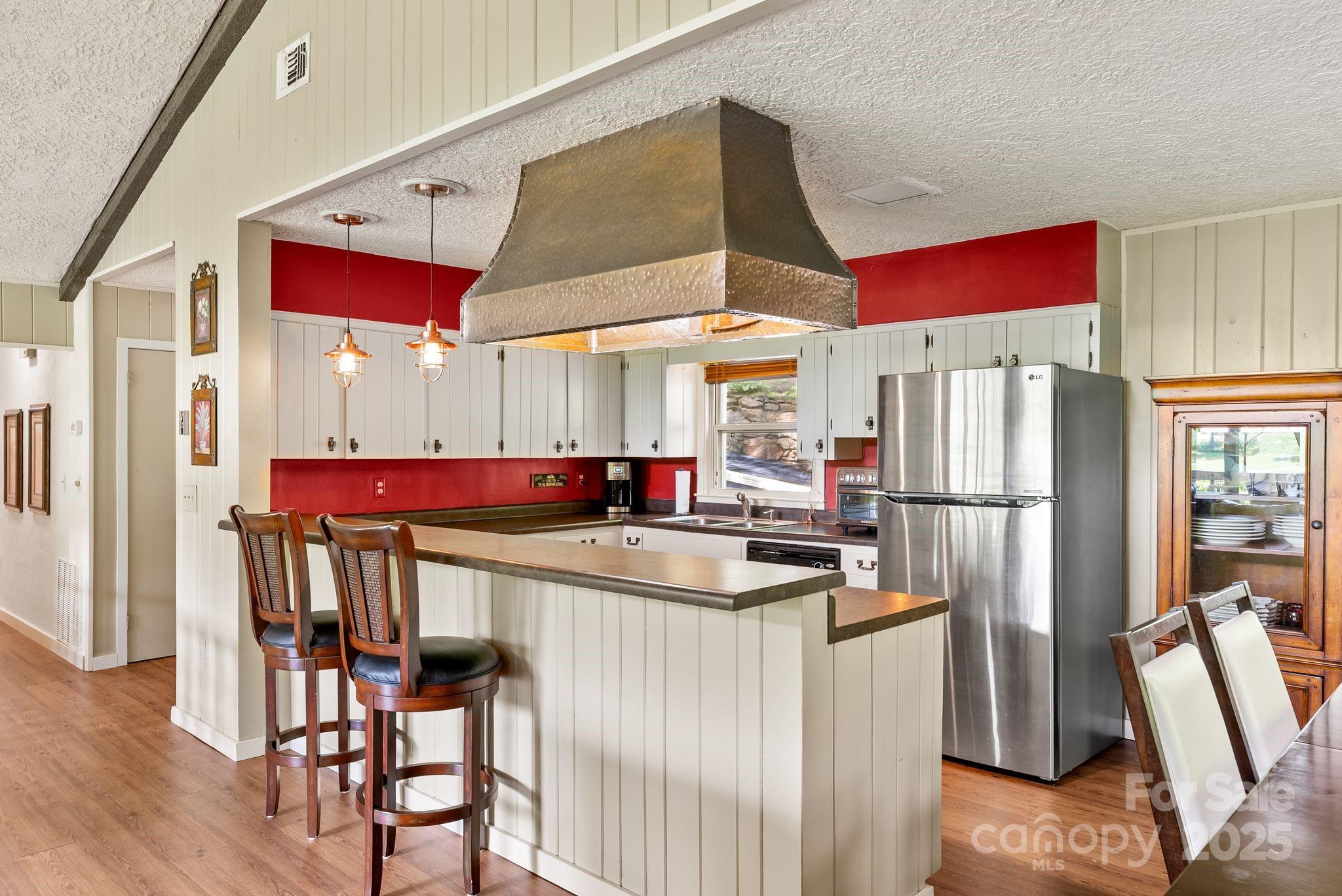 386 Country Club Drive Canton, NC 28716 - Photo 13 of 47 a kitchen with stainless steel appliances granite countertop a refrigerator and a table