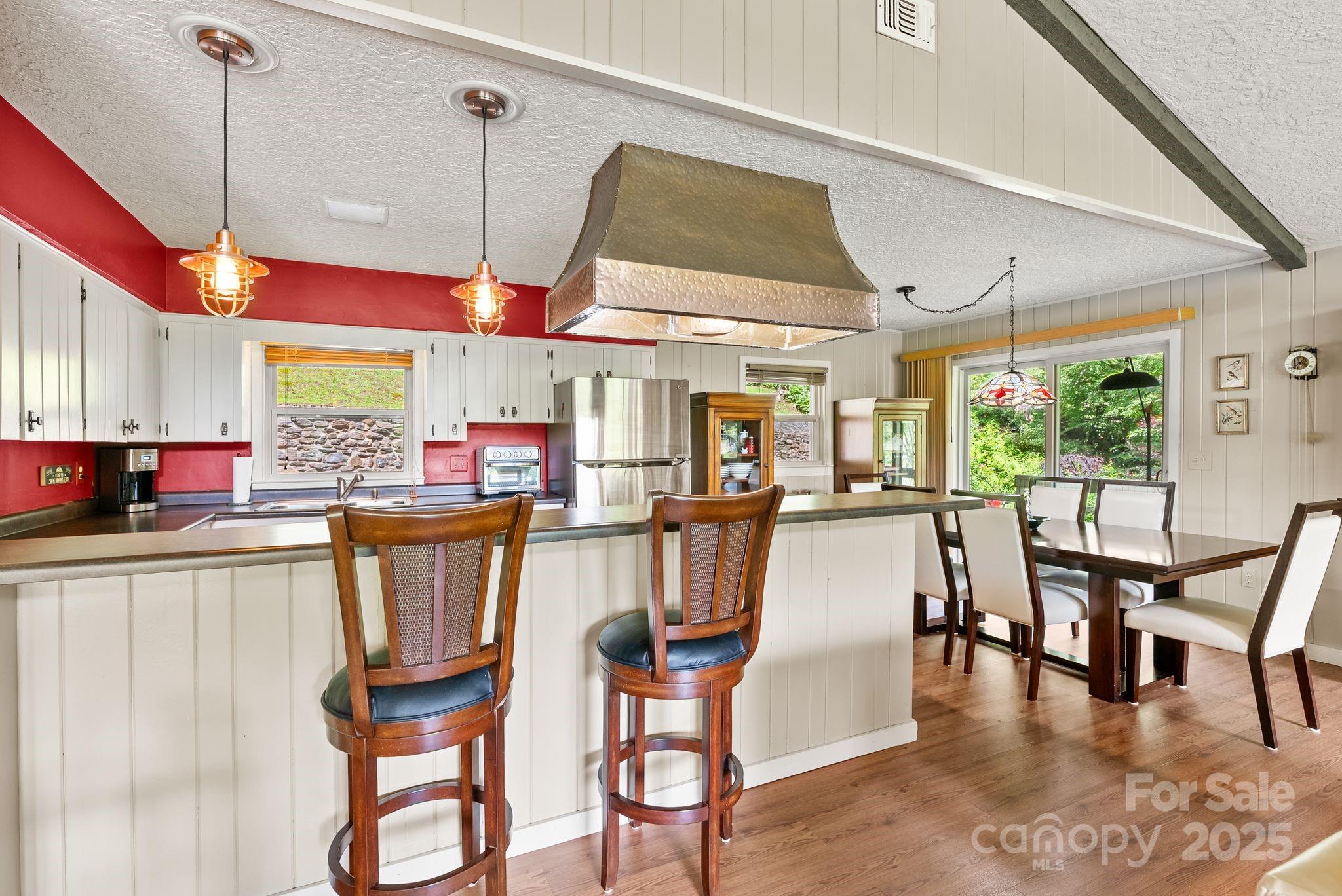 386 Country Club Drive Canton, NC 28716 - Photo 16 of 47 a dining area with glass top table and chairs
