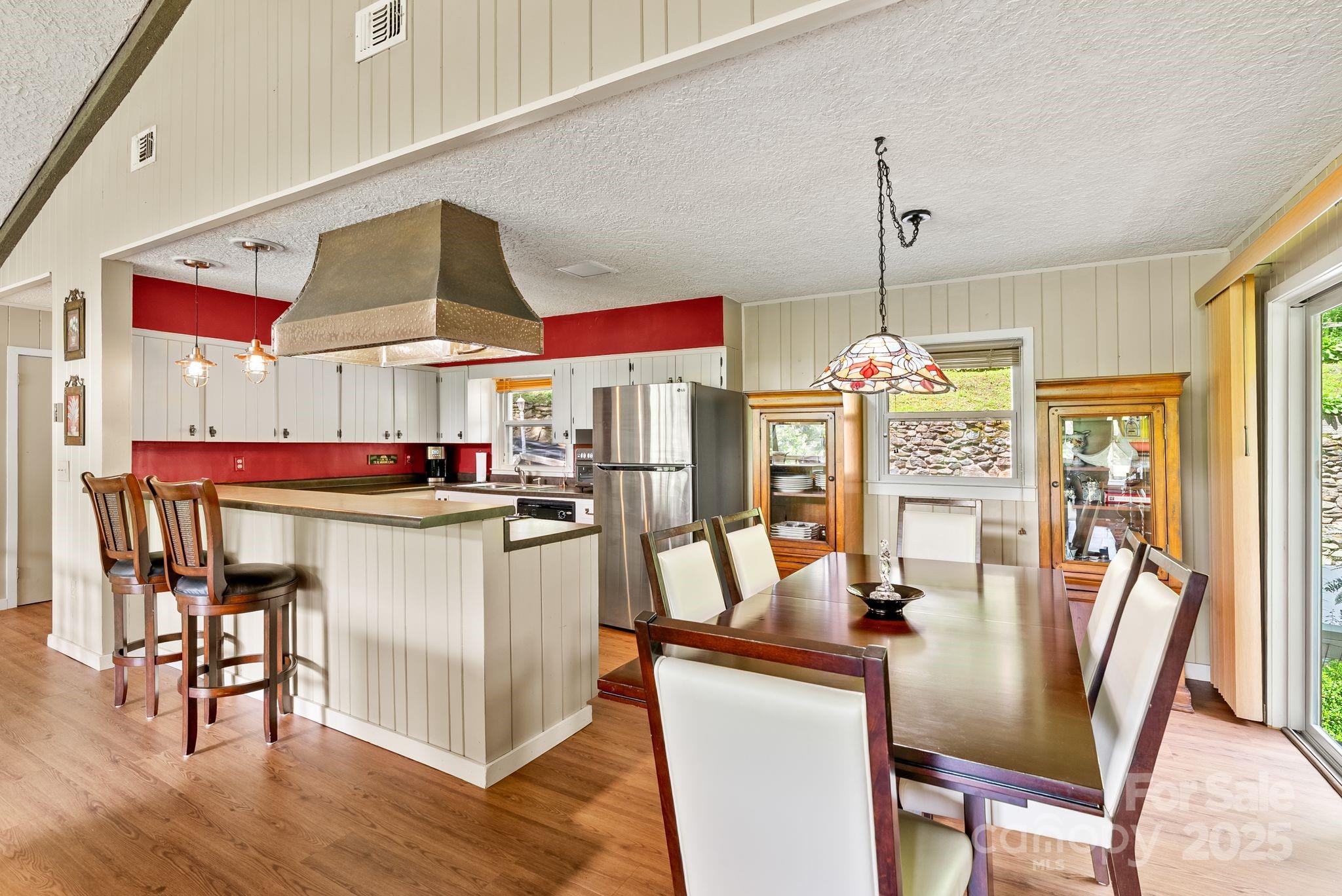 386 Country Club Drive Canton, NC 28716 - Photo 18 of 47 a dining area with a table chairs and a kitchen view