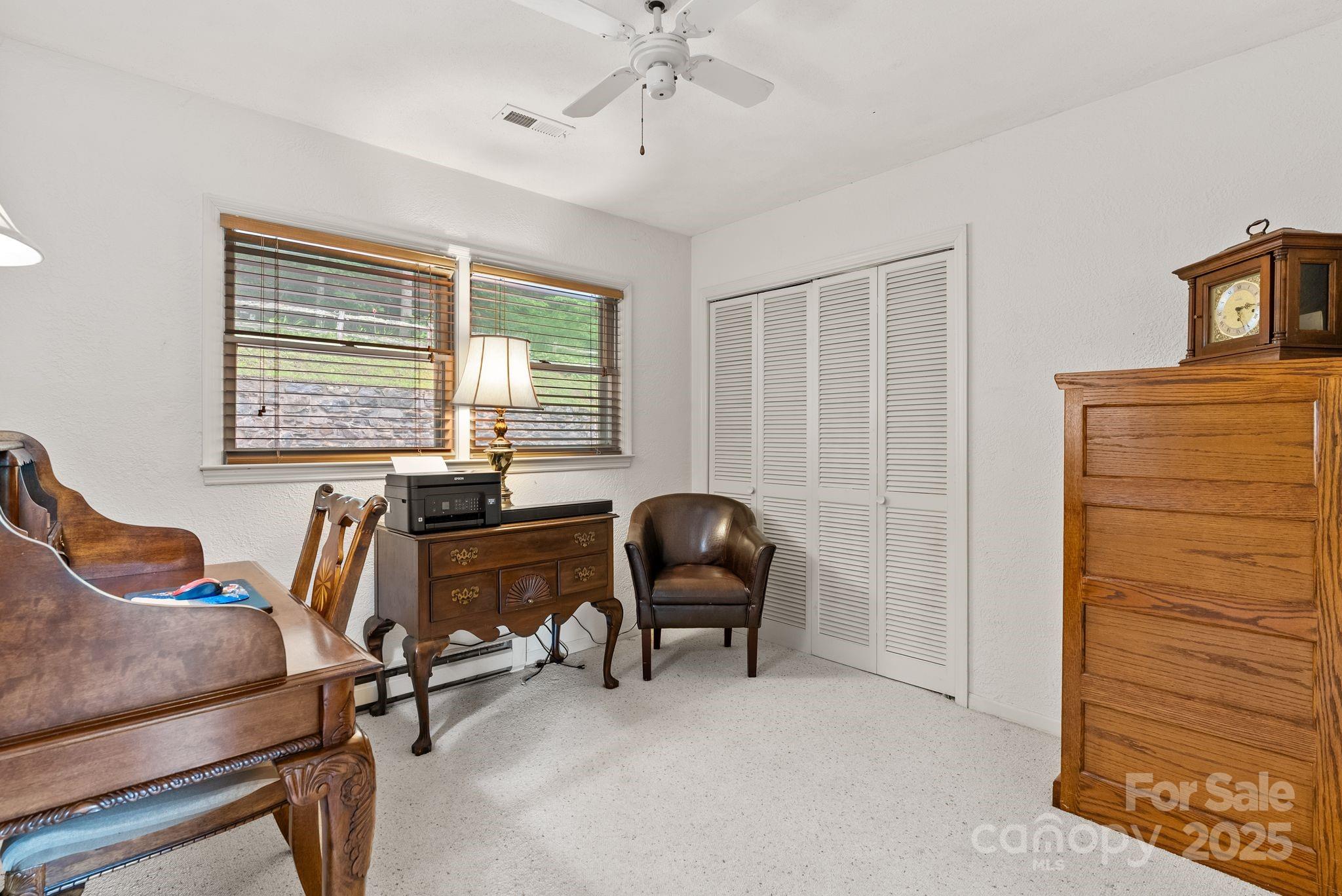 386 Country Club Drive Canton, NC 28716 - Photo 19 of 47 a view of a workspace with furniture and a window