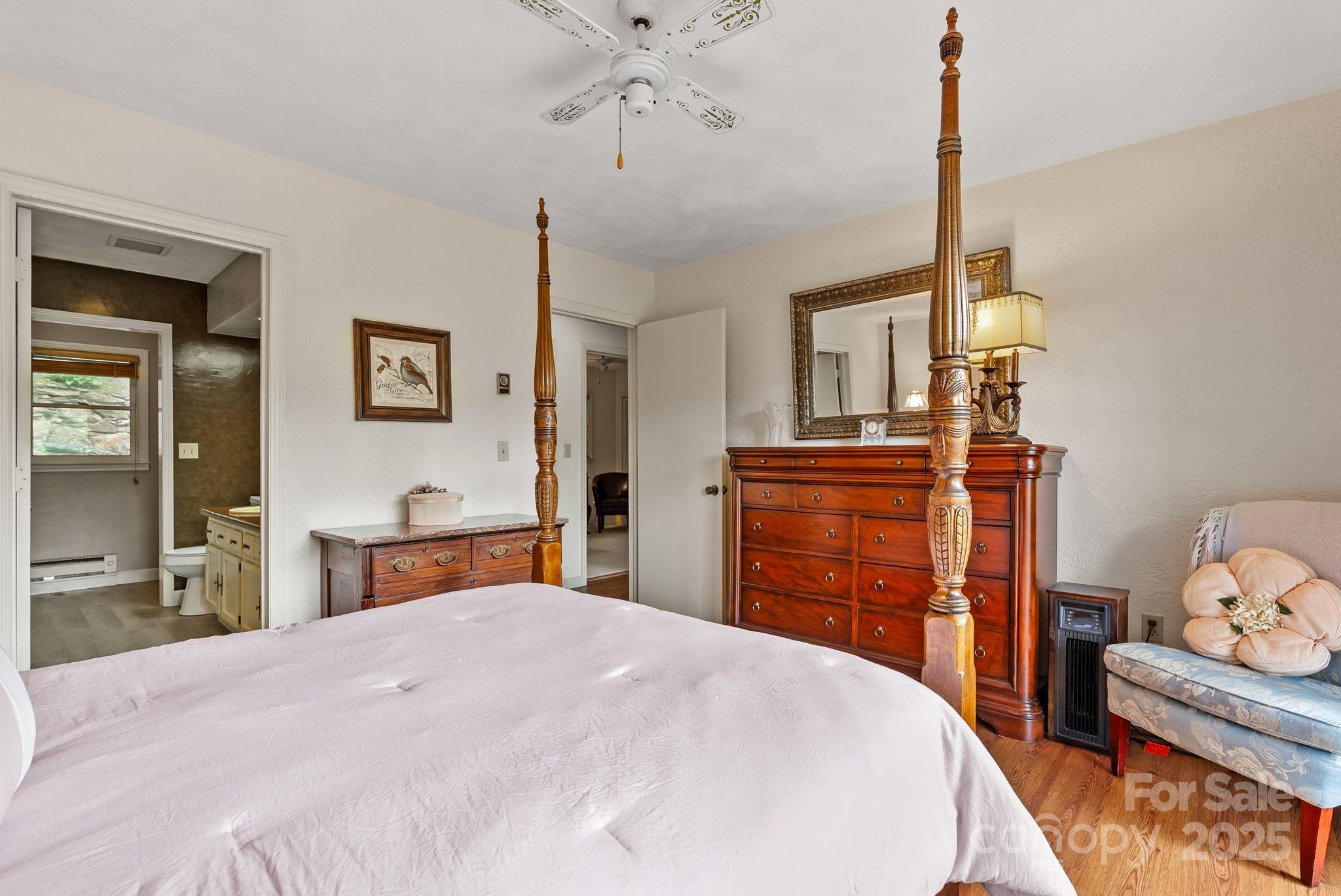 386 Country Club Drive Canton, NC 28716 - Photo 23 of 47 a bedroom with a bed and wooden floor