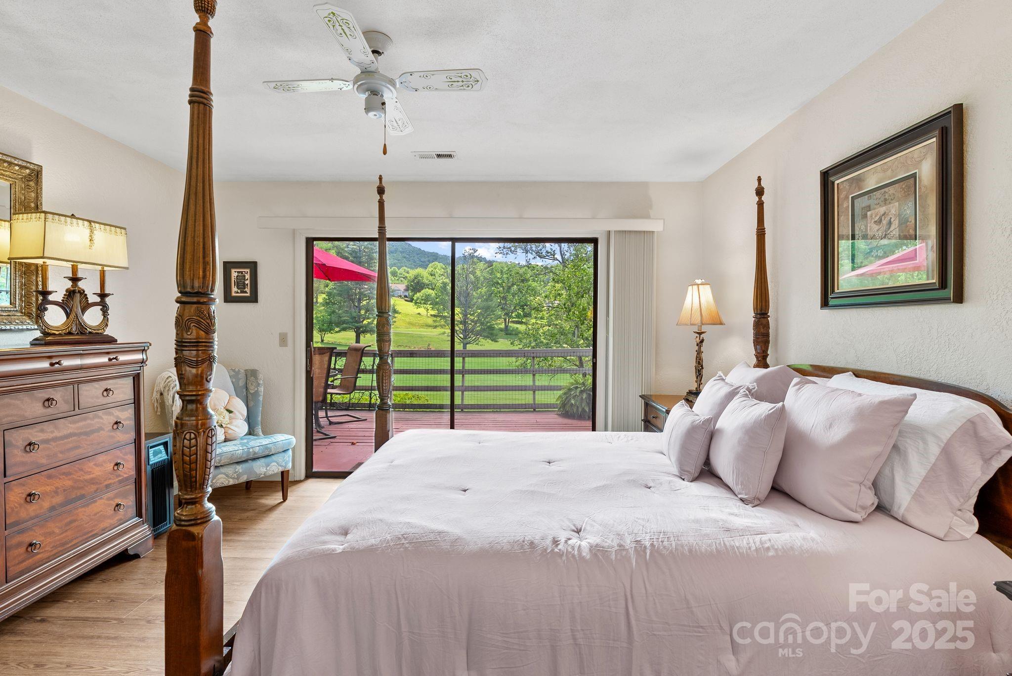 386 Country Club Drive Canton, NC 28716 - Photo 25 of 47 a bedroom with a bed and a chandelier