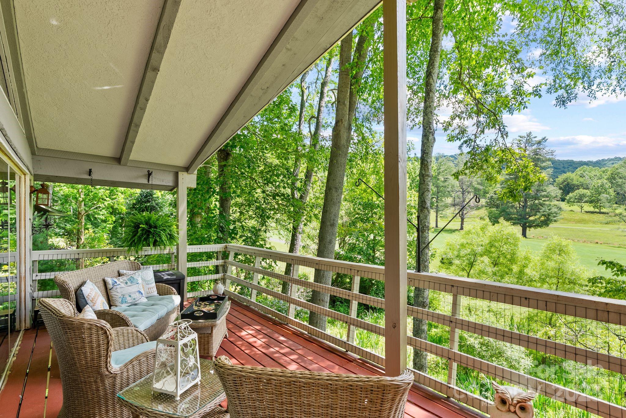 386 Country Club Drive Canton, NC 28716 - Photo 31 of 47 a view of a chair and tables in the balcony