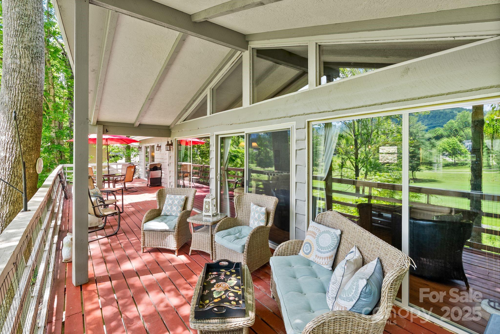 386 Country Club Drive Canton, NC 28716 - Photo 32 of 47 a living room with hardwood floor and large windows