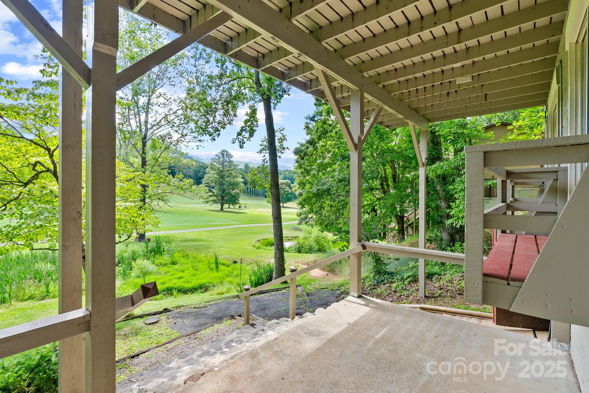 386 Country Club Drive Canton, NC 28716 - Photo 37 of 47 a view of a porch with furniture and garden