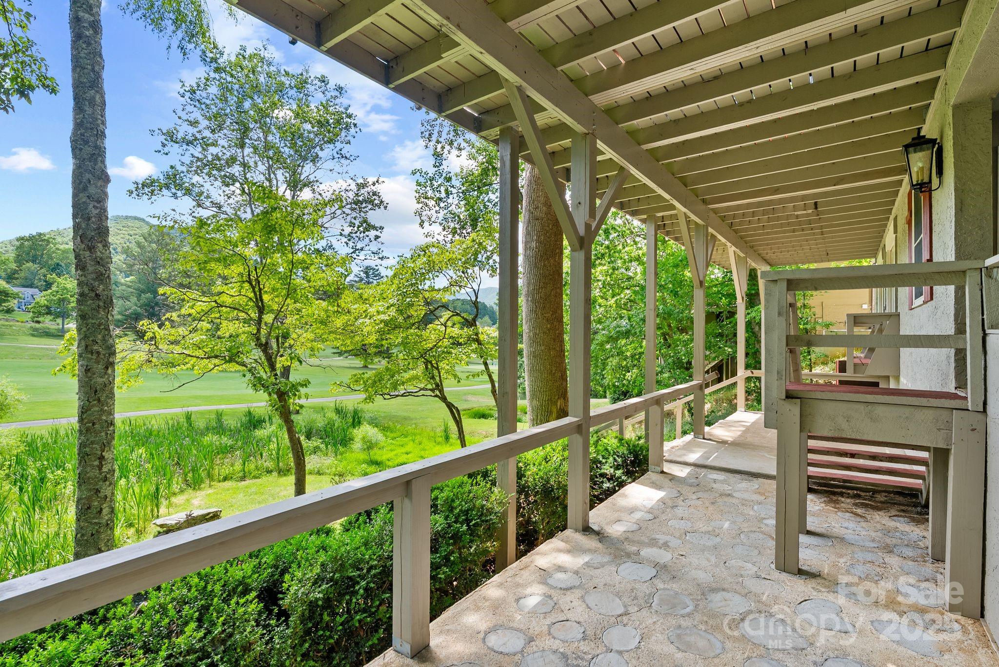 386 Country Club Drive Canton, NC 28716 - Photo 39 of 47 a view of a porch with furniture and a yard