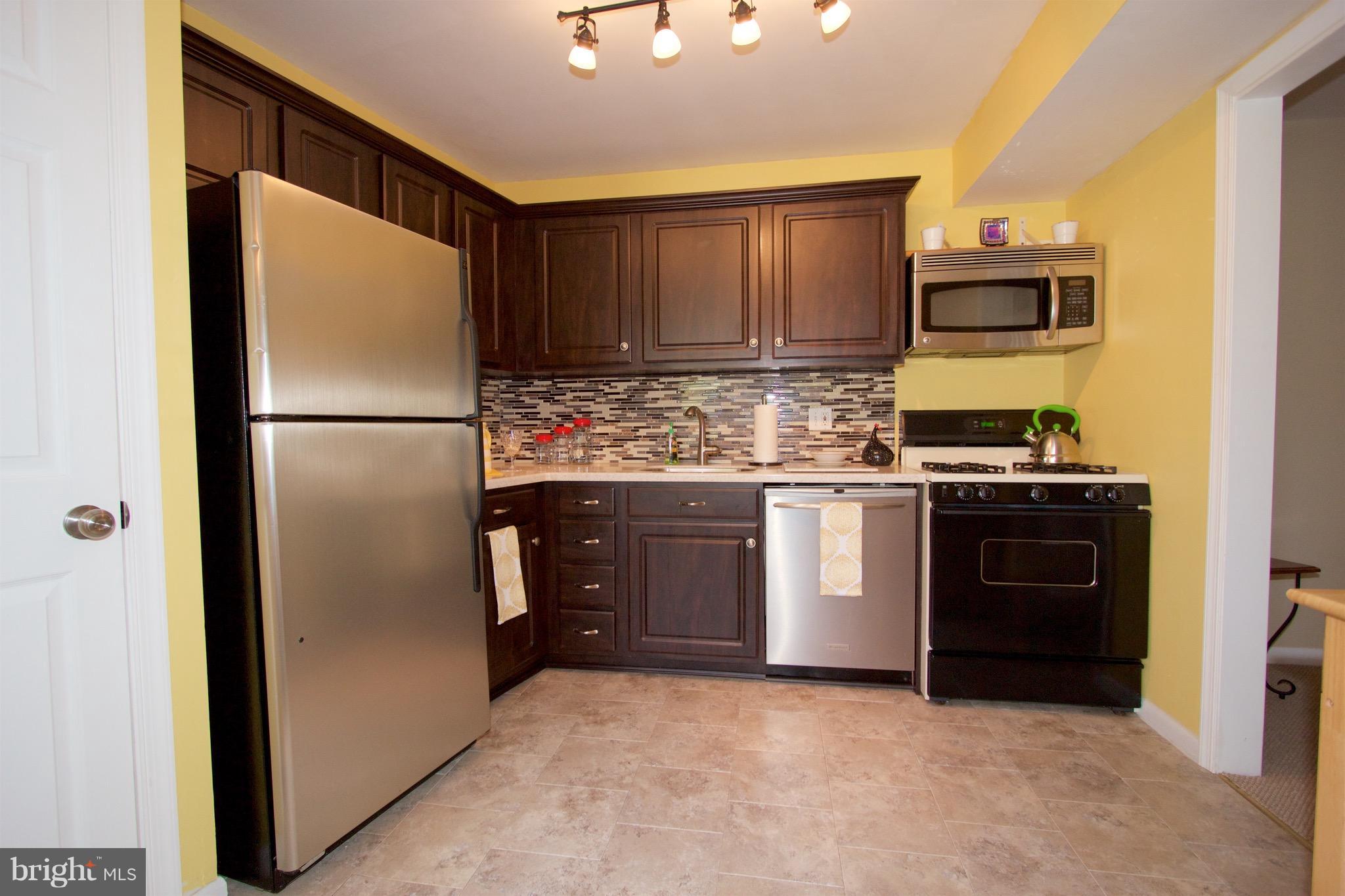 2507 Baltimore Road, Unit 1 Rockville, MD 20853 - Photo 1 of 30 a kitchen with stainless steel appliances granite countertop a refrigerator stove and sink