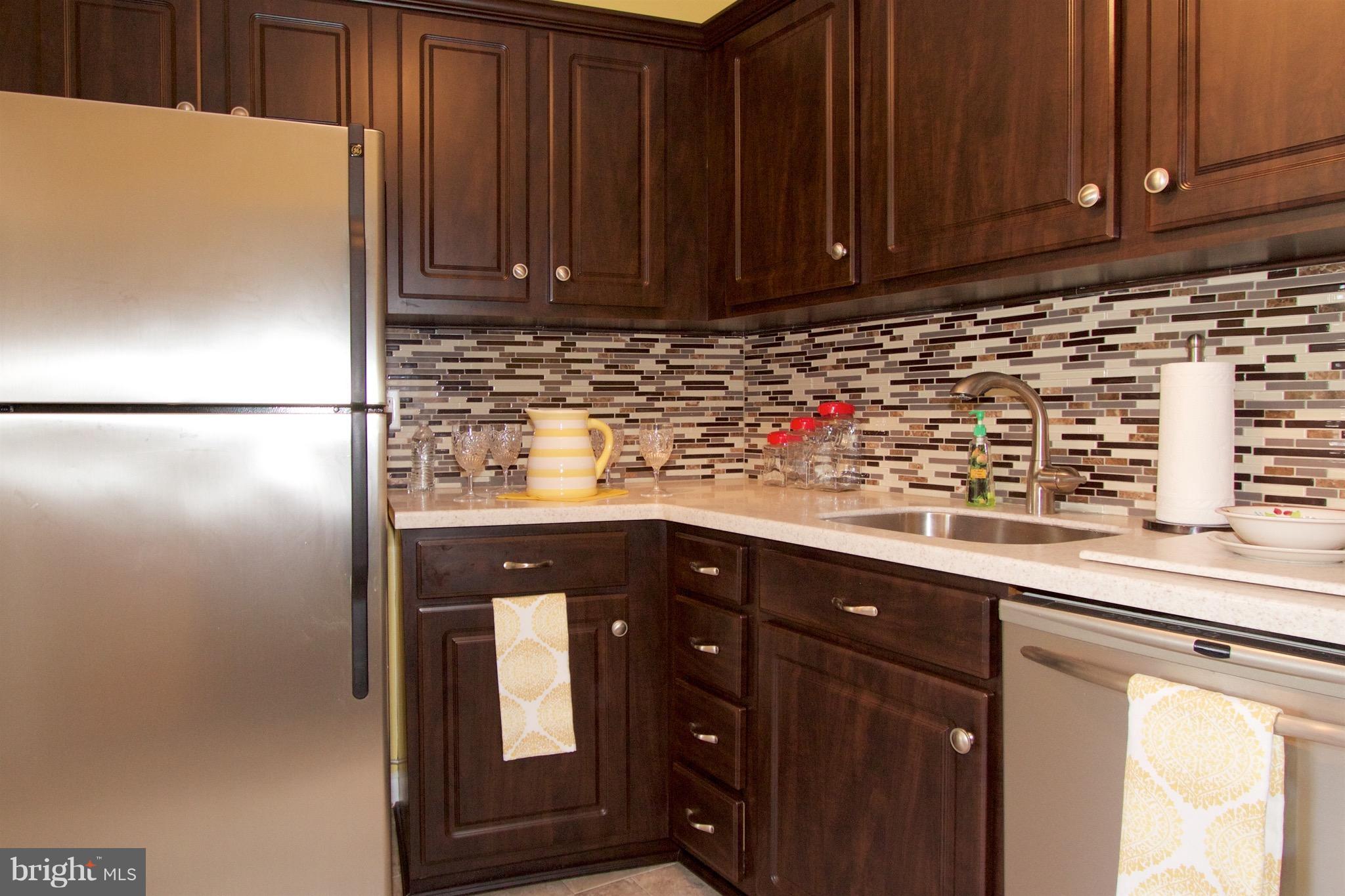 2507 Baltimore Road, Unit 1 Rockville, MD 20853 - Photo 2 of 30 a kitchen with stainless steel appliances granite countertop a refrigerator and a cabinets