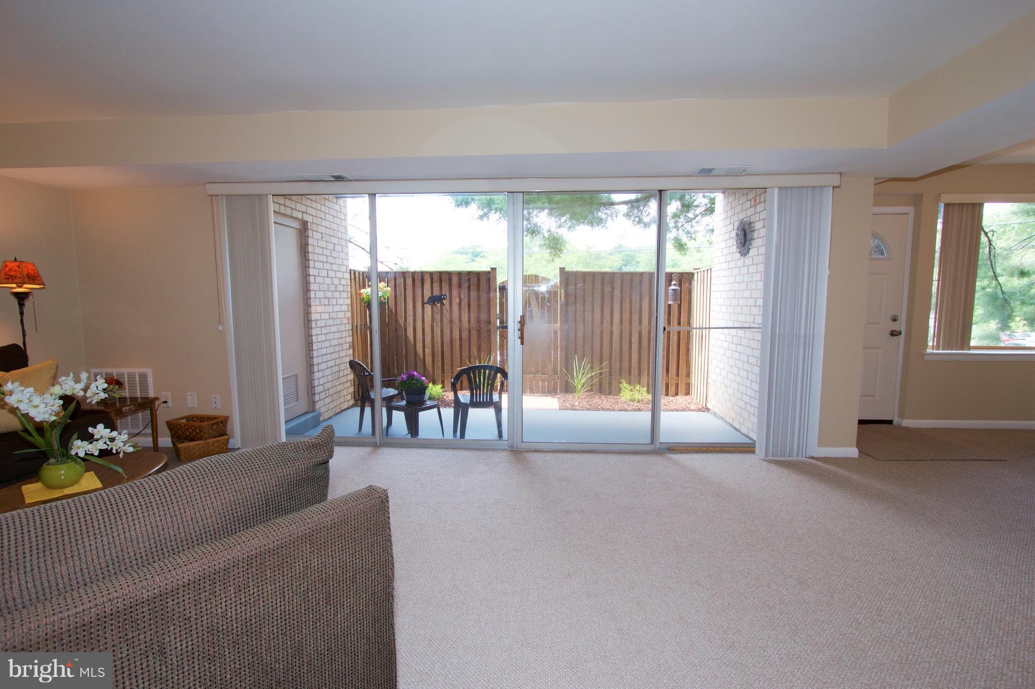 2507 Baltimore Road, Unit 1 Rockville, MD 20853 - Photo 11 of 30 a living room with furniture and a floor to ceiling window