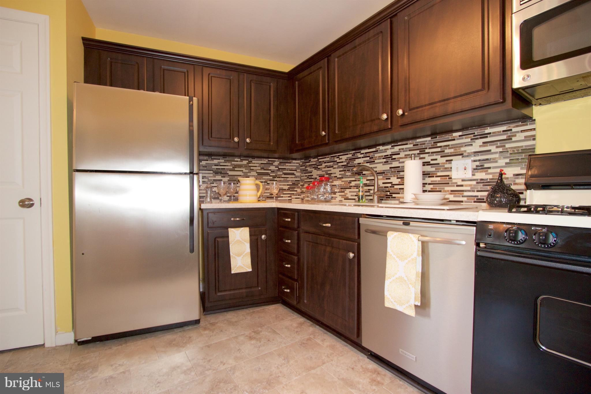 2507 Baltimore Road, Unit 1 Rockville, MD 20853 - Photo 3 of 30 a kitchen with stainless steel appliances granite countertop a refrigerator and a stove top oven