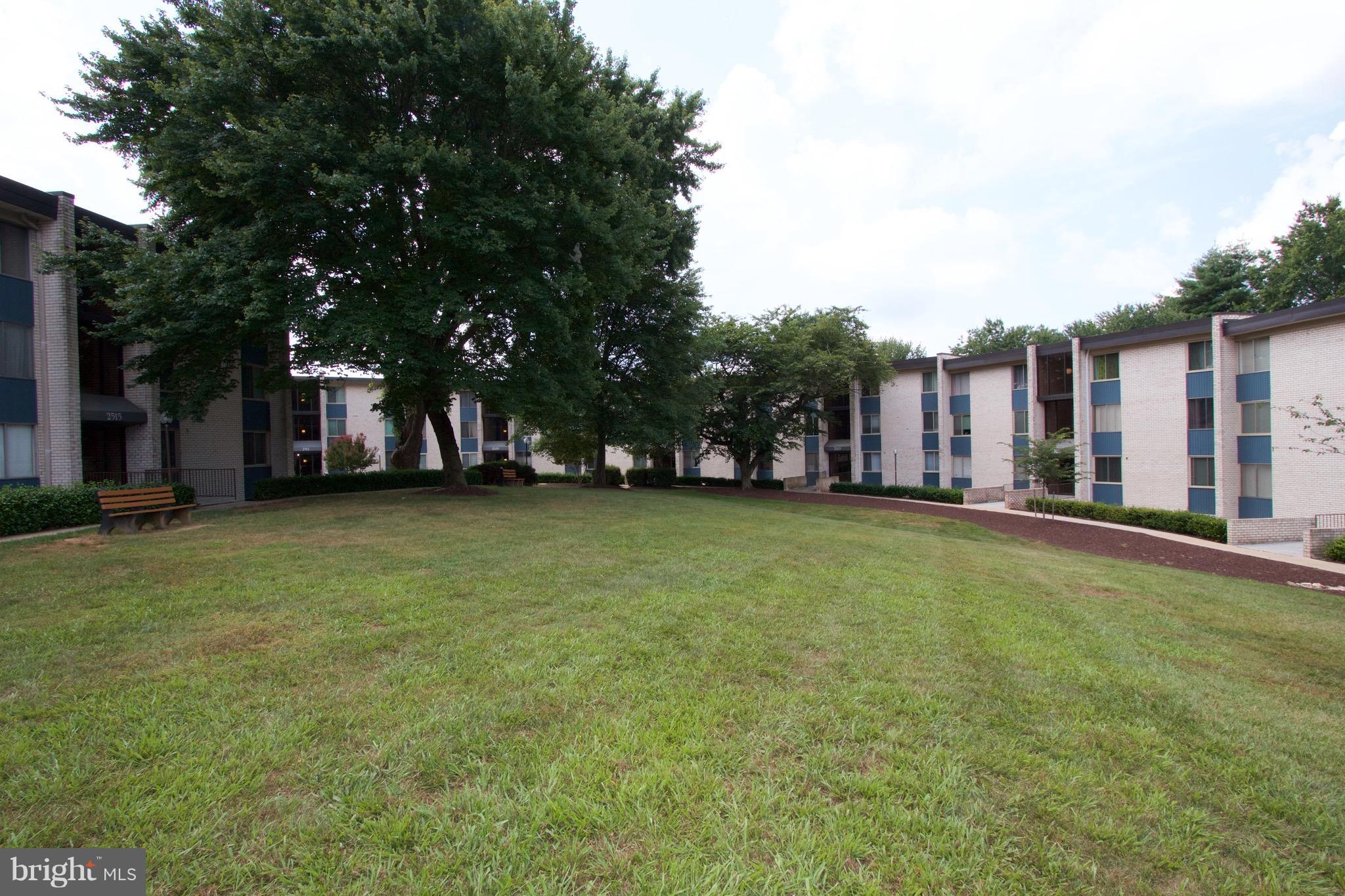 2507 Baltimore Road, Unit 1 Rockville, MD 20853 - Photo 26 of 30 a view of a house with a big yard and large tree