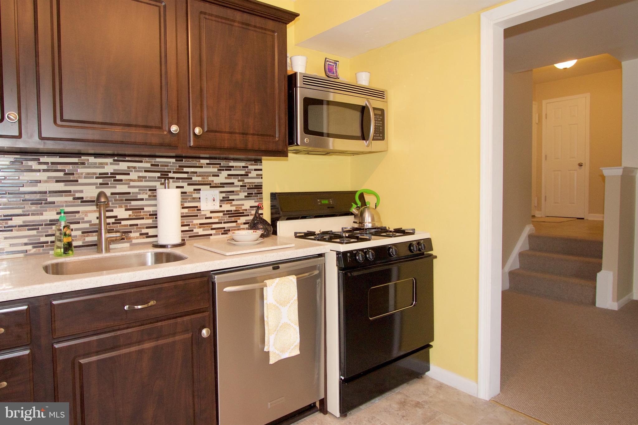 2507 Baltimore Road, Unit 1 Rockville, MD 20853 - Photo 5 of 30 a kitchen with stainless steel appliances granite countertop a sink stove and microwave