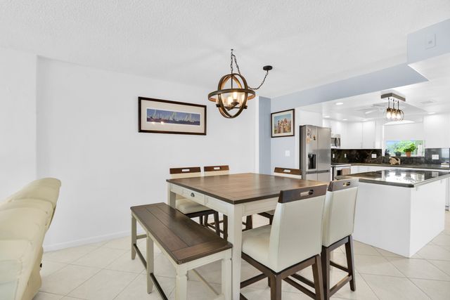a spacious bedroom with a bed and a chandelier