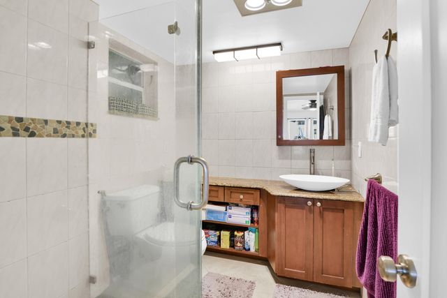a bathroom with a granite countertop sink a mirror and vanity