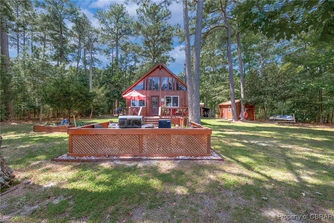 5447 Mobjack Road Gloucester, VA 23061 - Photo 18 of 40 Rear view of house featuring a storage shed, a wooden deck, and a lawn