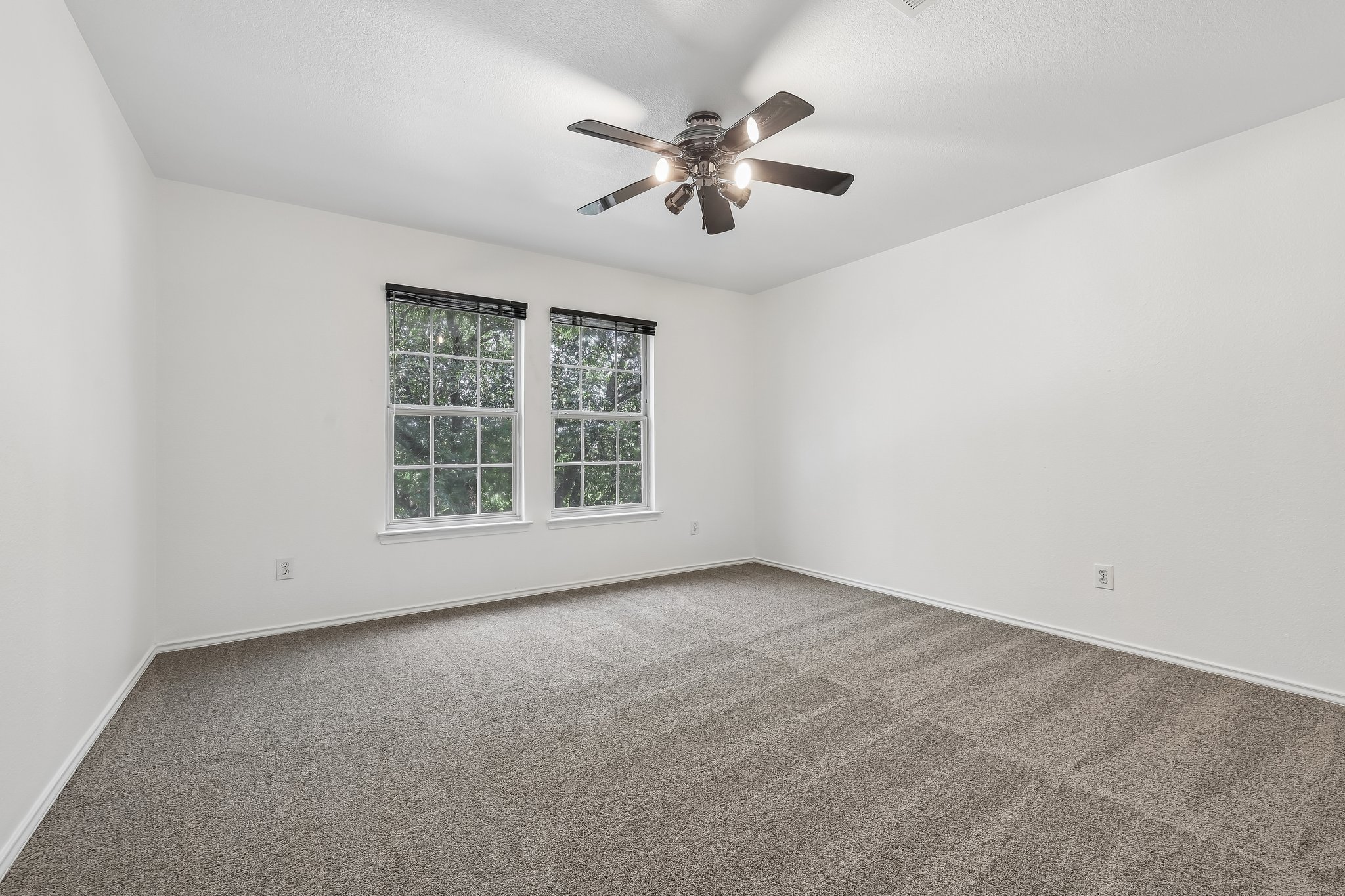7658 Marble Ridge Drive Austin, TX 78747 - Photo 28 of 34 an empty room with windows and fan