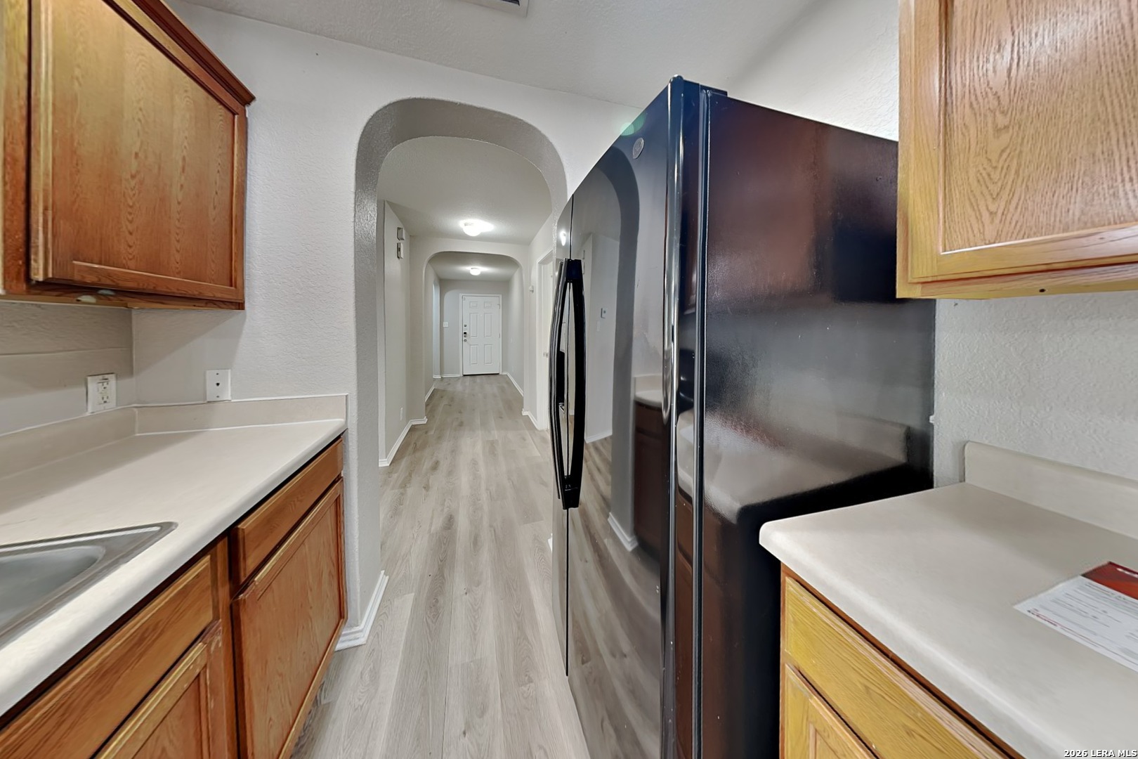 6510 Poseidon Way Converse, TX 78109 - Photo 5 of 16 a kitchen with a refrigerator and a sink