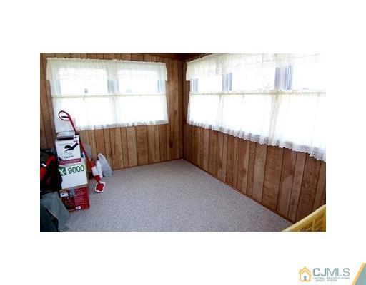38 Lancaster Road Colonia, NJ 07067 - Photo 11 of 14 a picture of a room with a window and a ceiling fan