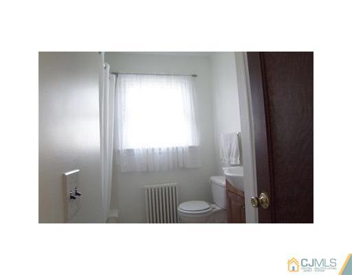38 Lancaster Road Colonia, NJ 07067 - Photo 6 of 14 a bathroom with a sink and a mirror