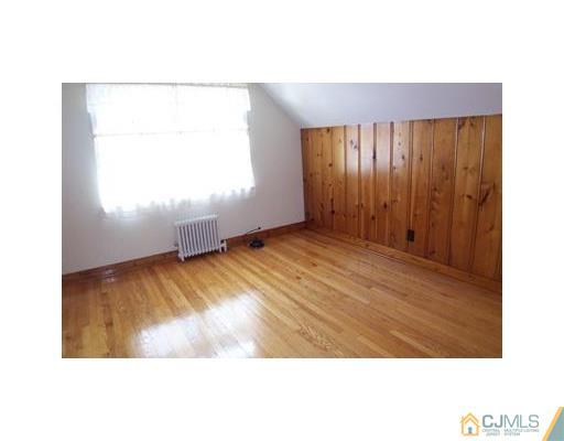 38 Lancaster Road Colonia, NJ 07067 - Photo 9 of 14 a view of an empty room with wooden floor
