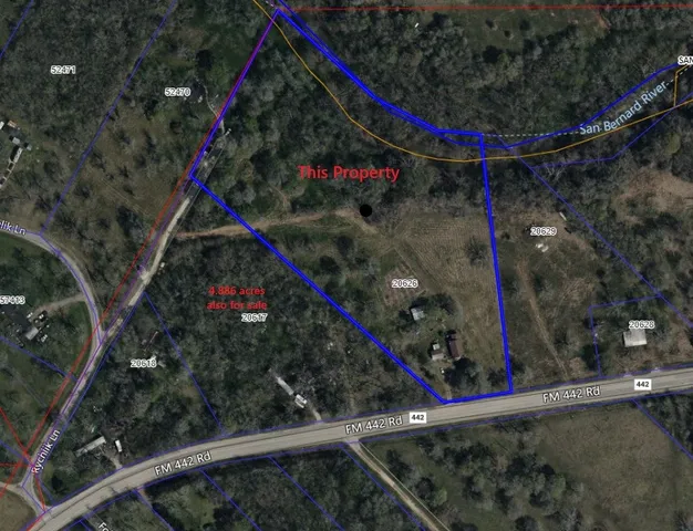 a backyard of a house with lots of green space and glass windows