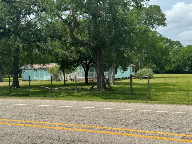 a dining room with wooden floor and outdoor seating