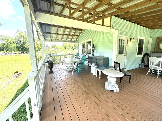 a living room with furniture flowerpot and wooden floor