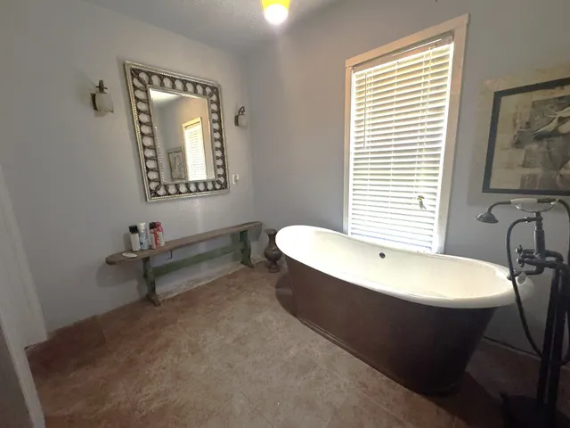 a view of a chairs and table in patio with wooden floor