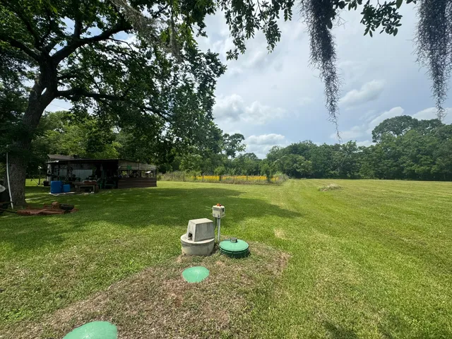 a view of a house with a backyard