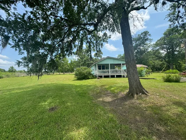 a view of outdoor space with a garden and trees