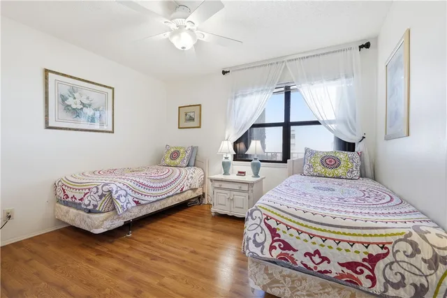 a bedroom with a bed dresser and window