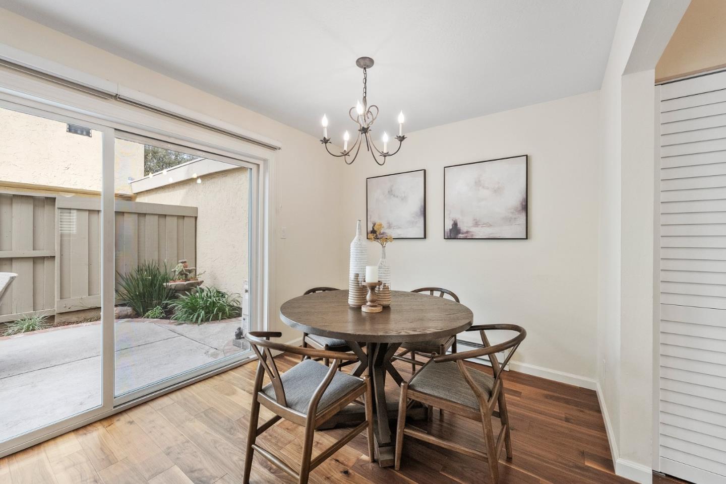 4017 Gold Run Way San Jose, CA 95136 - Photo 8 of 25 a dining room with wooden floor a chandelier a wooden table and chairs