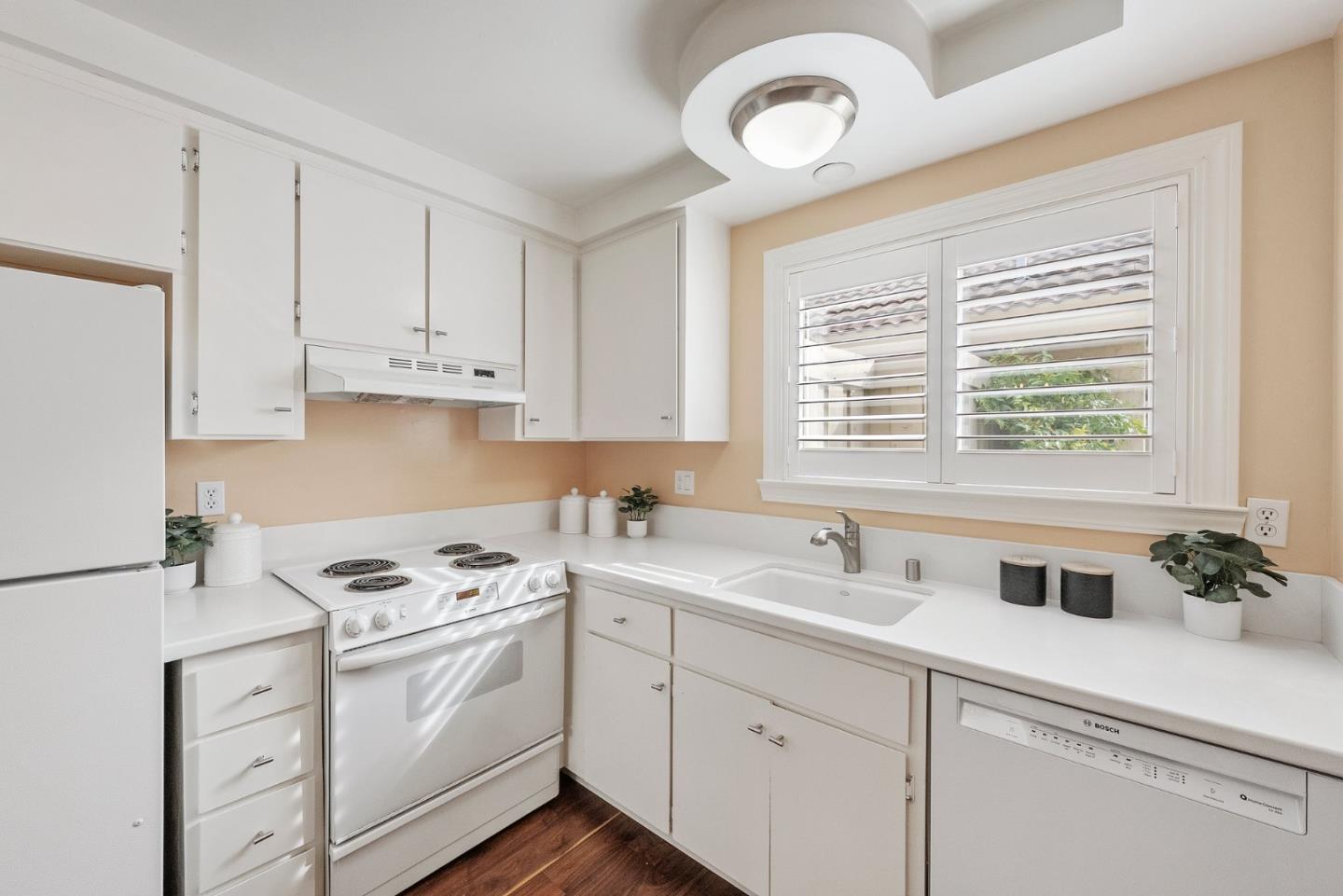 4017 Gold Run Way San Jose, CA 95136 - Photo 10 of 25 a kitchen with appliances cabinets a sink and a window