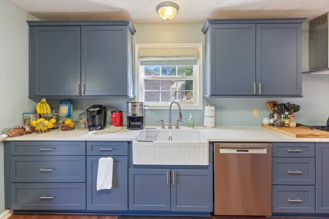 a kitchen with appliances cabinets and a window