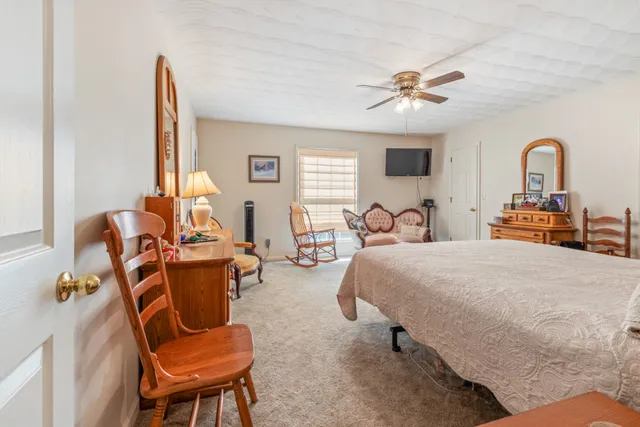 a bedroom with furniture and a window