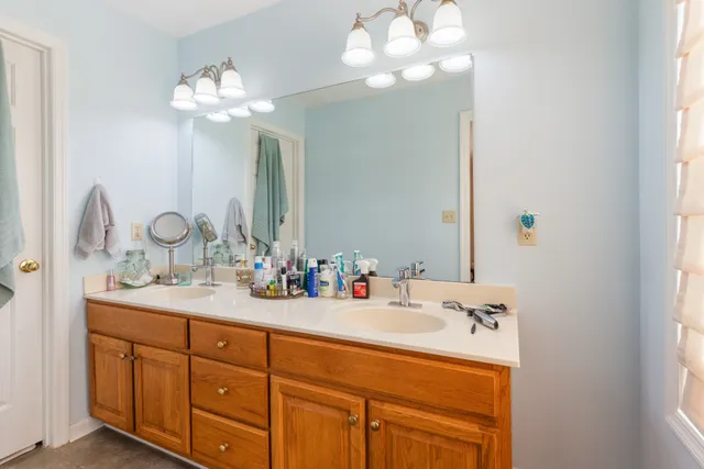 a bathroom with a double vanity sink and a mirror
