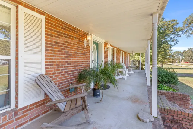 a view of backyard with outdoor seating and plants