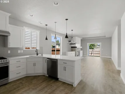 a kitchen with lot of cabinets and wooden floor