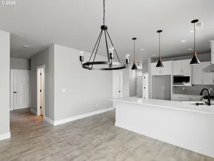 a view of a kitchen with a sink and refrigerator