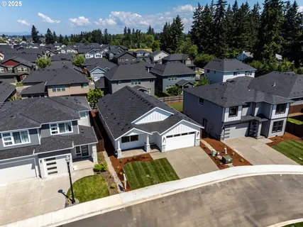 an aerial view of residential houses with city view
